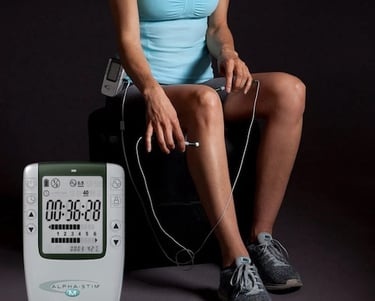 Young woman applying Alpha Stim M on her knee.