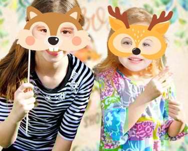 two girls in striped shirts and masks with deer faces