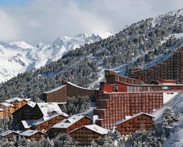 Snow-covered Les Arcs mountain resort buildings showing Charlotte Perriand’s alpine design connectio