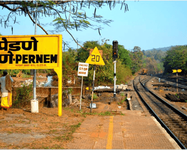 a pernem train station with a sign board