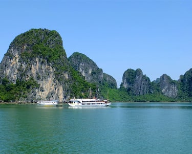 a boat in the water with a mountain in the background