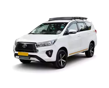White Toyota Innova Crysta one way taxi by Saini taxi services with a luggage carrier rack