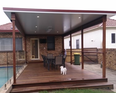 Insulated panel roof over a spotted gum deck