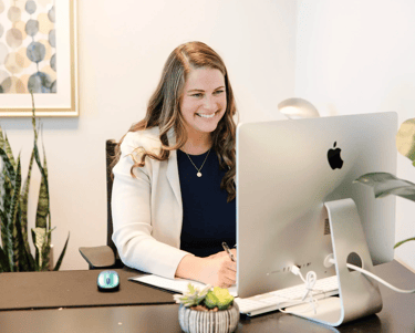 A picture of Lindsay smiling while on a video call with a client.