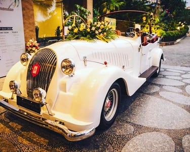 a vintage car with a bride and groomsmen