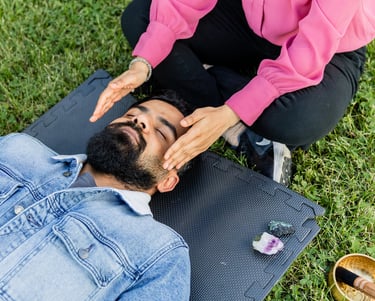A woman doing a reiki session in the park