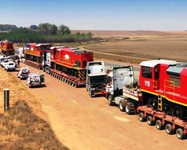 a train is being loaded with a trailer