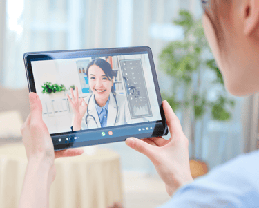 a woman in a doctor's office is holding a tablet computer