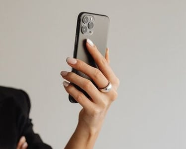 Person holding a smartphone while recording content for social media.