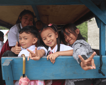 a group of children in school uniforms posing for a picture