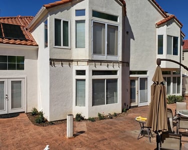 White 2 story home with spanish tile after balcony was removed.
