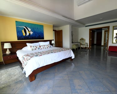 a bedroom with a bed and a painting on the wall