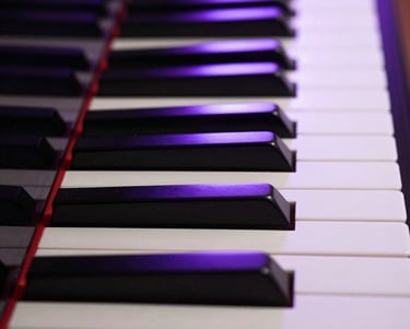 Macro shot of grand piano keys reflecting deep purple studio LEDs, low-key atmospheric lighting, symmetrical composition