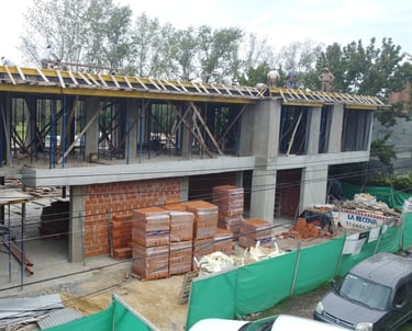 a building being built into a house with a roof that is being built into a