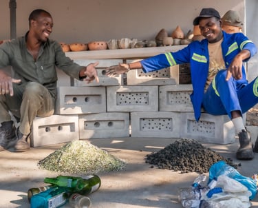two men rejoicing after making bricks from upcycled plastic and glass