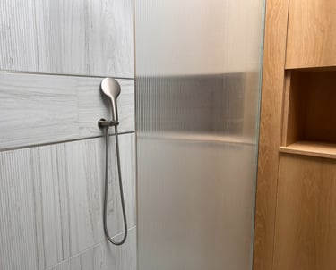 fluted tiles and oak in shower room