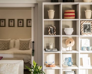 guest suite with soft neutral tones and decorative shelving at Villa El Olivo, Marbella