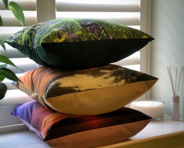 A cushion stack of 3 pillows with nature photography prints and soft touch velvet or faux suede back