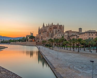 Palma De Mallorca famous building Infront of water with mountain in distance