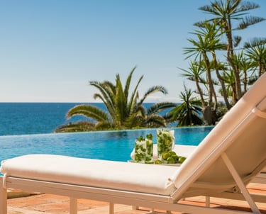 Pool area at Villa El Rincon in Marbella with ocean views, designer furnishings, and open-concept Mediterranean design
