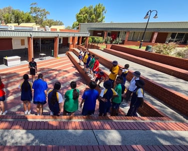 a group of children and adults standing in a line learning life skills