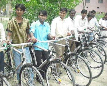 a group of men standing around a row of bicycles