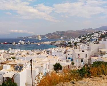 whitehouses looking at coast of Mykonos Greece with cruise ship in distance