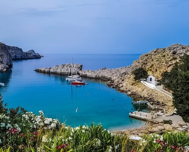 Rhodes Greece ships on water surrounded by rocks and flowers