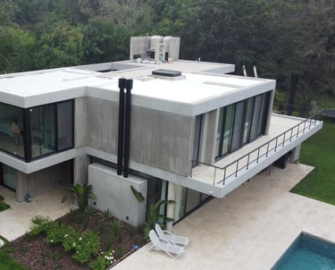 a house with a large roof and a pool