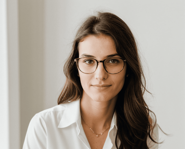 a woman in glasses and a white shirt
