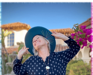 Kandace, co-owner of Green Bee Laser Cleaning & Restoration, smiling by a garden fountain
