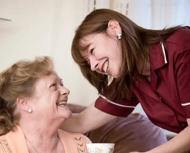 AMG Nurse giving patient a cup of tea