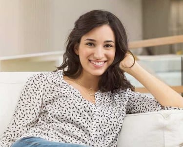 a woman sitting on a couch with her legs crossed