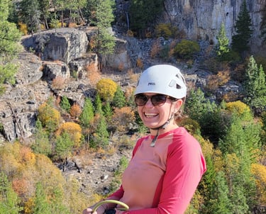 Nat smiling at the top of a climb in Skaha