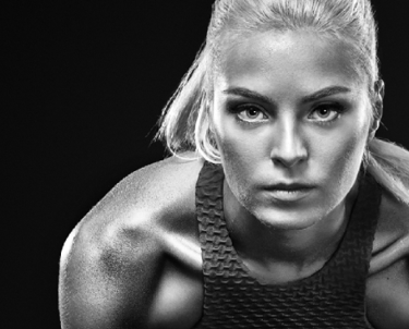 a female tennis player in a sports top with a tenns racket