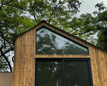 a bamboo house with a large window