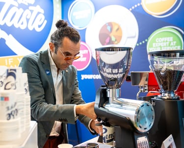 Matteo grinding coffee during Host Milan 2023