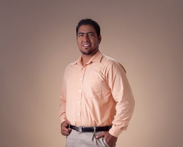 a man in a pink shirt and tan pants