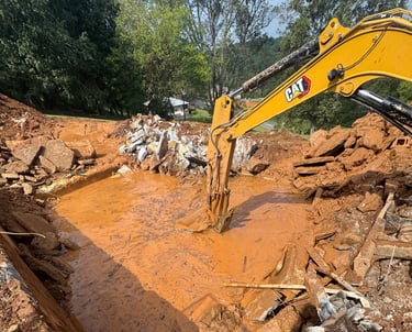 excavator digging out concrete pool