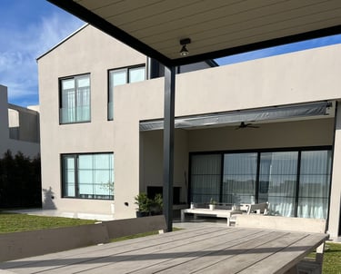 a table with a table and chairs in front of a house