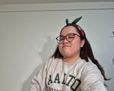 a woman in a grey Aalto university sweater