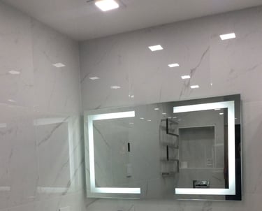 a bathroom with a large mirror and a sink