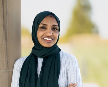 a woman in a white dress and black scarf