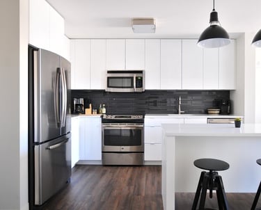 a kitchen with a refrigerator, microwave, and a microwave