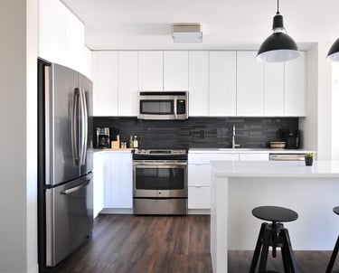a kitchen with a refrigerator, microwave, and a microwave