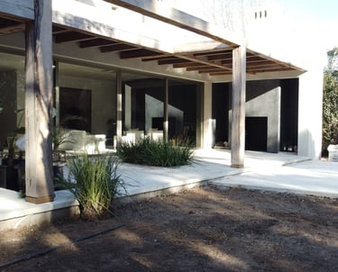 a house with a pool and a pool in the background