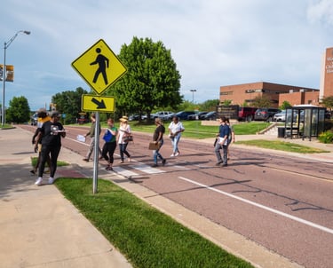 Group of people walking across a crosswalk
