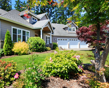 Residential landscape with layered perennials, shrubs, and a well-kept WNY garden.