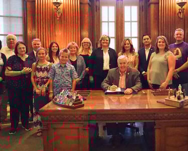 Large group of people in the governor's office, posing for a picture