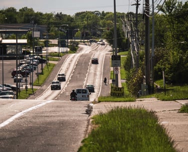 Cars on a busy road, and you can see fumes on the street